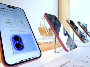 A display of iPhone 16s in an Apple store