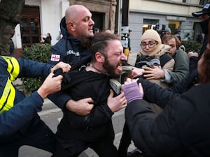 Police detain a protester during a rally in Tbilisi, Georgia