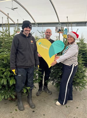 Jenny Bean from Severn Hospice with manager Tom Pountney and Harry Bramley  from Love Plants with Christmas trees.