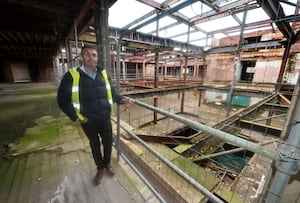 Hiten Raghwani stands on the first floor, at the top of where the escalator once was